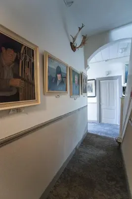 a hallway with paintings on the walls of a building at Hotel Faber in Zandvoort
