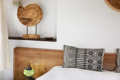 a bedroom with a bed with a wooden headboard at Guest House Aquarius in Zandvoort