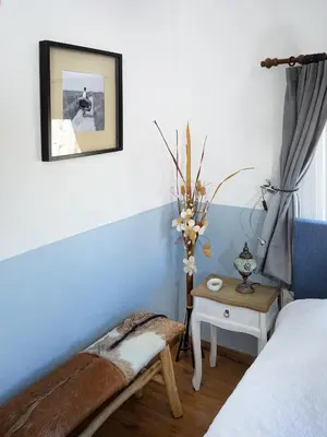 a bedroom with a bed and a table with a vase at Guest House Aquarius in Zandvoort