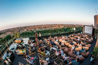 a crowd of people sitting on the roof of a building at Leonardo Hotel Amsterdam Rembrandtpark in Amsterdam