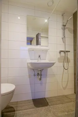 a bathroom with a sink and a toilet at Appartementen Zeezicht in Katwijk aan Zee