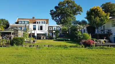 a large house with a yard in front of it at Edam, Garden Room with private entrance and rural view in Edam