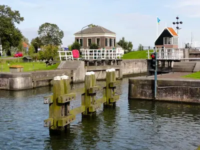 a house on the side of a river at Edam, Garden Room with private entrance and rural view in Edam