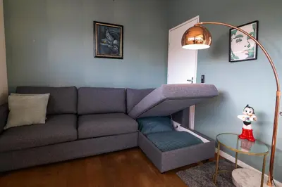 a living room with a couch and a table at Newly renovated houseboat The Waterhouse in Amsterdam