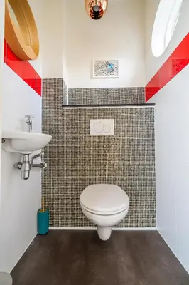 a bathroom with a toilet and a sink at Newly renovated houseboat The Waterhouse in Amsterdam