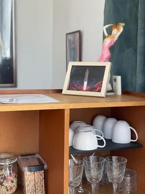 a shelf with a picture and glasses on it at Newly renovated houseboat The Waterhouse in Amsterdam