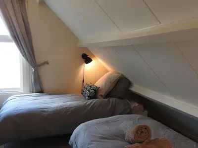 a room with two beds in a attic at Holiday Home in Noordwijkerhout near Lake in Noordwijkerhout