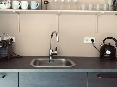 a kitchen counter with a sink in a kitchen at Holiday Home in Noordwijkerhout near Lake in Noordwijkerhout