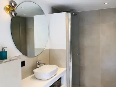 a bathroom with a sink and a mirror at Holiday Home in Noordwijkerhout near Lake in Noordwijkerhout