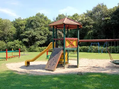 a playground with a slide and a gazebo at Holiday Home in Noordwijkerhout near Lake in Noordwijkerhout