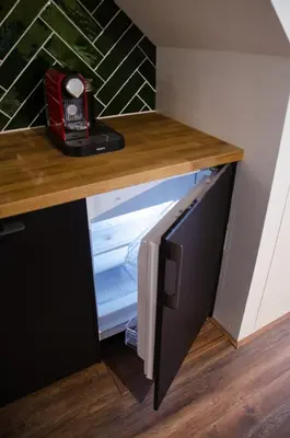 an open refrigerator in a room with a counter at Dorpsplein Appartement in Zandvoort