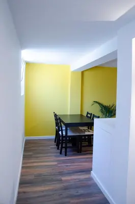 a dining room with a table and chairs at Dorpsplein Appartement in Zandvoort