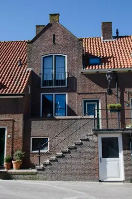 a brick building with stairs on the side of it at Dorpsplein Appartement in Zandvoort