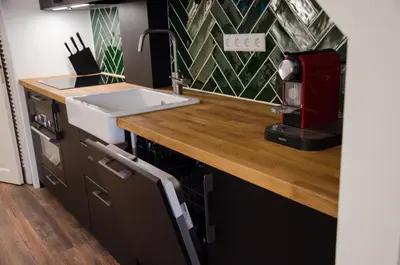 a kitchen with a sink and a counter top at Dorpsplein Appartement in Zandvoort
