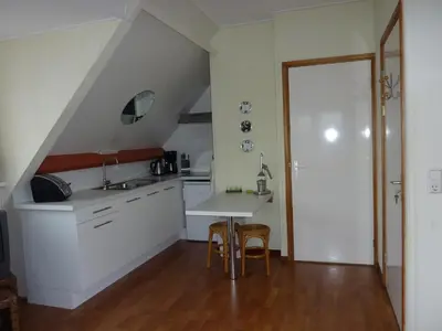 a kitchen with a table and chairs in a room at Studio Zandvoort in Zandvoort