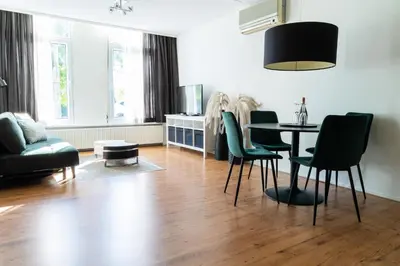 a living room with a table and chairs at Frankendael Apartments in Amsterdam