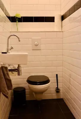 a bathroom with a toilet and a sink at Frankendael Apartments in Amsterdam