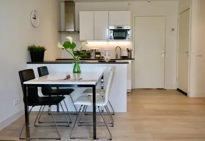 a kitchen and dining room with a table and chairs at Frankendael Apartments in Amsterdam