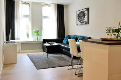 a living room with a couch and a table at Frankendael Apartments in Amsterdam