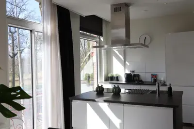 a kitchen with a black counter and a window at Frankendael Apartments in Amsterdam