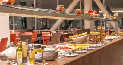a buffet line with plates of food on a table at PLAZA Premium Almere in Almere