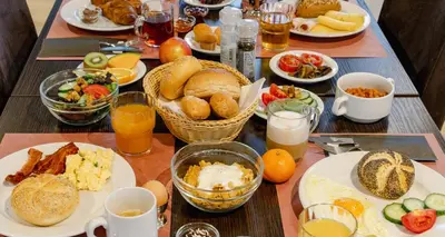 a table topped with plates of breakfast foods and drinks at PLAZA Premium Almere in Almere