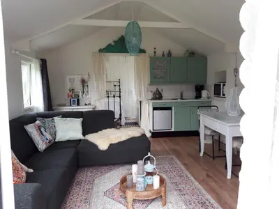 a living room with a couch and a table at Rietzicht in Alkmaar
