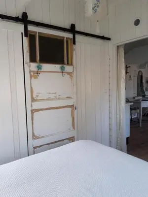 a bedroom with a white bed and a window at Rietzicht in Alkmaar