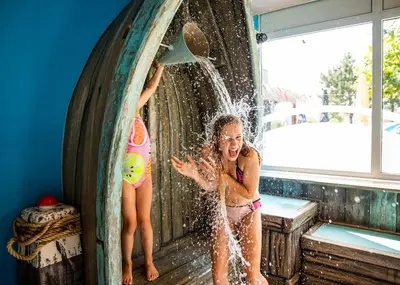 two young girls playing in a water fountain at EuroParcs Parc du Soleil in Noordwijk aan Zee