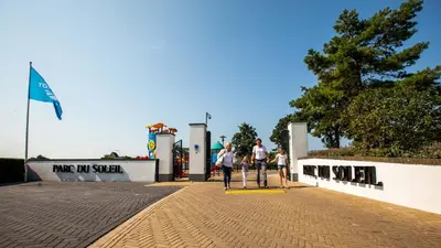 a group of people walking down a sidewalk at EuroParcs Parc du Soleil in Noordwijk aan Zee