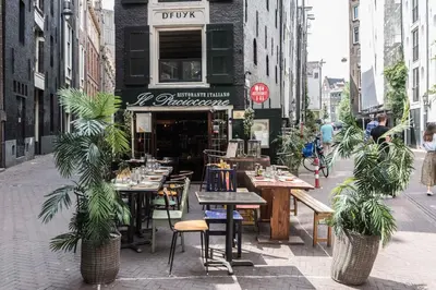 a restaurant with tables and chairs on a city street at Anny's Warehouse City Centre! in Amsterdam