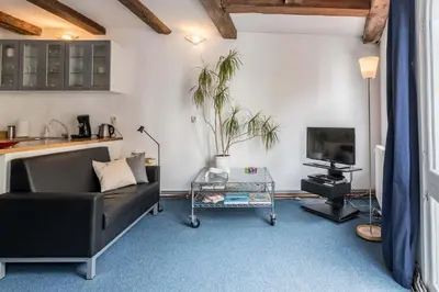 a living room with a couch and a tv at Anny's Warehouse City Centre! in Amsterdam