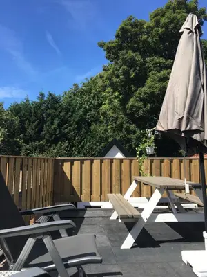 a patio with a picnic table and an umbrella at ECHT-Bergen in Bergen