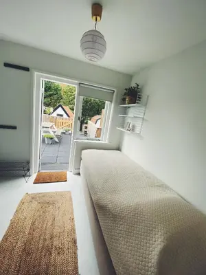 a bedroom with a bed and a large window at ECHT-Bergen in Bergen
