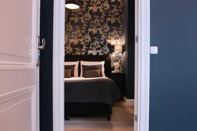a bedroom with a bed with a black wall at Grand Canal Boutique Hotel in Amsterdam