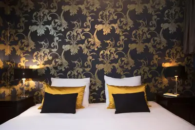 a bedroom with a bed with yellow pillows at Grand Canal Boutique Hotel in Amsterdam