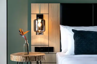 a bedroom with a bed and a table with a lamp at Renaissance Amsterdam Schiphol Airport Hotel in Schiphol