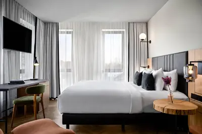a hotel room with a large bed and a desk at Renaissance Amsterdam Schiphol Airport Hotel in Schiphol