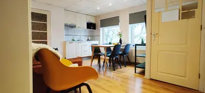 a kitchen and dining room with a table and chairs at Appartementen Dorp & Duin in Egmond aan Zee