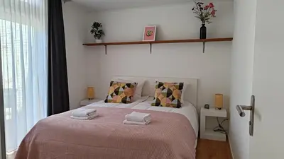 a bedroom with a bed with two towels on it at Appartementen Dorp & Duin in Egmond aan Zee