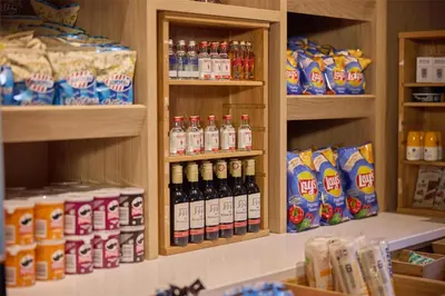 a store filled with lots of bottles of soda at Hilton Garden Inn Leiden in Leiden