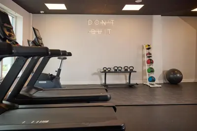 a gym with a treadmill and a sign that says dont quit at Hilton Garden Inn Leiden in Leiden