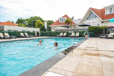 two people in the swimming pool at a house at EuroParcs Noordwijkse Duinen in Noordwijk aan Zee