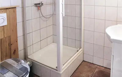 a shower with a glass door in a bathroom at Het Appelhuisje in Wijdenes