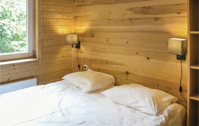 a bedroom with a white bed with two pillows at Het Appelhuisje in Wijdenes