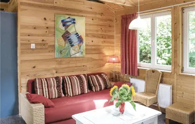 a living room with a red couch and wooden walls at Het Appelhuisje in Wijdenes
