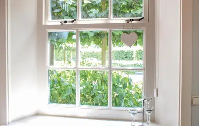 a window with two wine glasses in front of it at Het Vissershuisje in Wijdenes