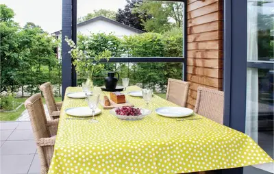 a table with a yellow polka dot table cloth at Das Sommerhus 68 in Noordwijk aan Zee
