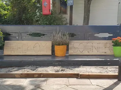 a bench with a sign that says pleaseseveresevere written on it at Appartement Soigner! in Egmond-Binnen
