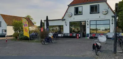 a building with bikes parked in front of it at Appartement Soigner! in Egmond-Binnen